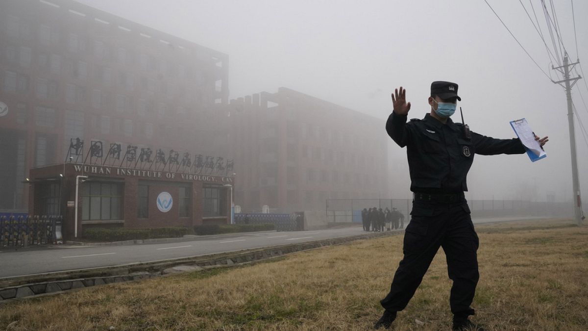 FILE - A security officer turns journalists away from the Wuhan Institute of Virology after a World Health Organization team arrived in Wuhan, Hubei province, Feb 3 2021