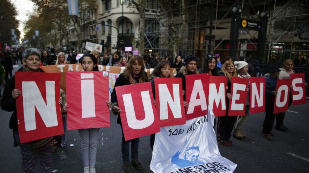 FILE: Demonstrators hold placards with a phrase that reads in English