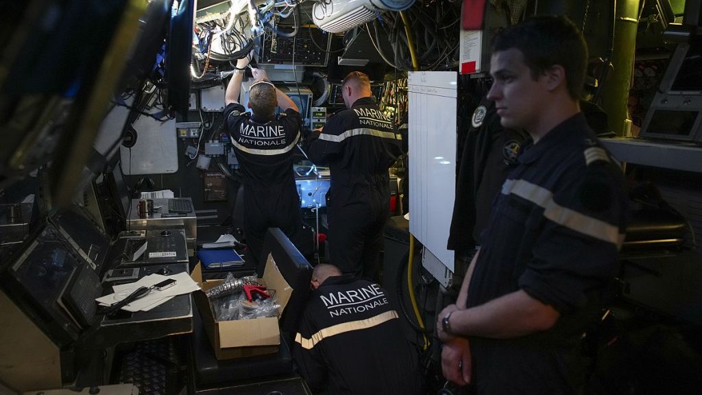 Sailors prepare a French Rubis-class submarine at the Toulon naval base in southern France, Monday, April 15, 2024.