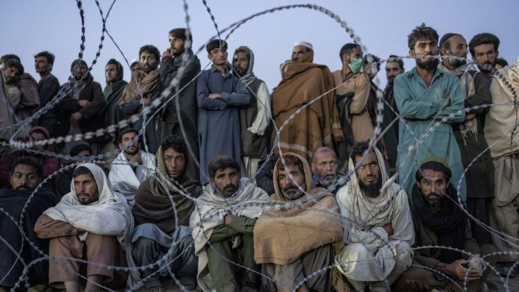 FILE - Afghan refugees wait to register in a camp near the Torkham Pakistan-Afghanistan border in Torkham, Afghanistan, Saturday, Nov. 4, 2023.