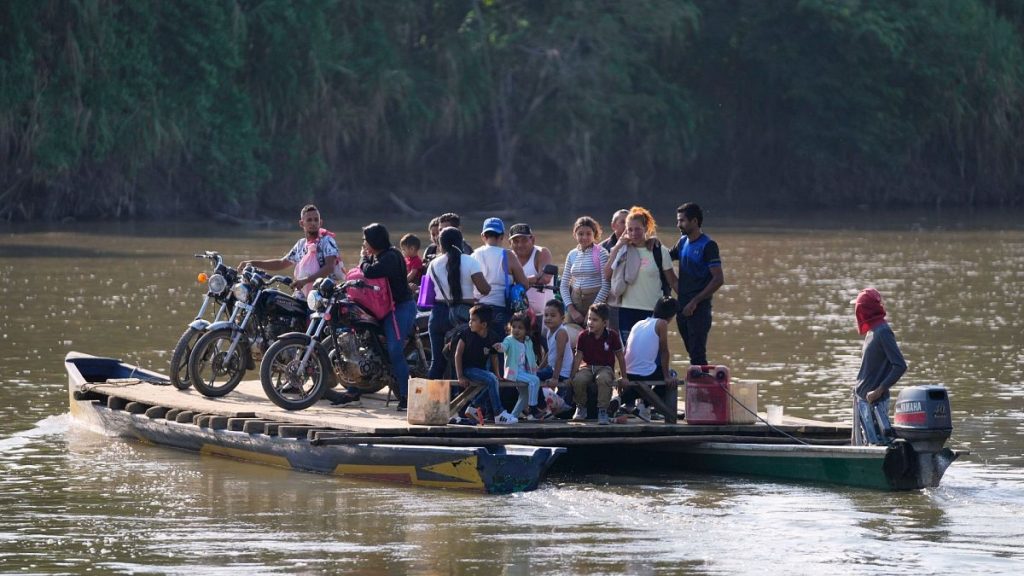 Residents cross a river to Venezuela from Colombia