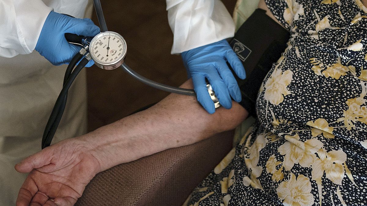 FILE - A doctor checks the blood pressure of A 94-year-old woman in Sant Sadurní d