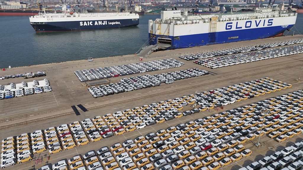 Vehicles and trucks for export wait for transportation from a port in Yantai in eastern China