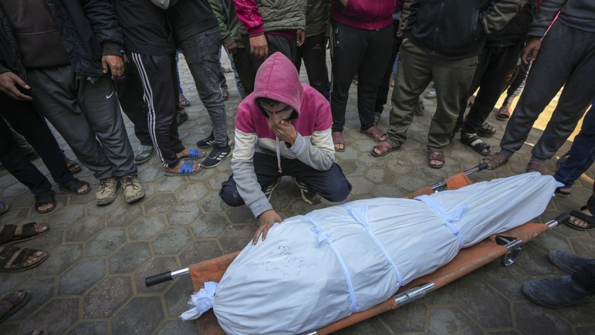 A man weeps over the body of a Palestinian killed in an Israeli army strike in Deir al-Balah in the Gaza Strip, Thursday 2 January 2025.