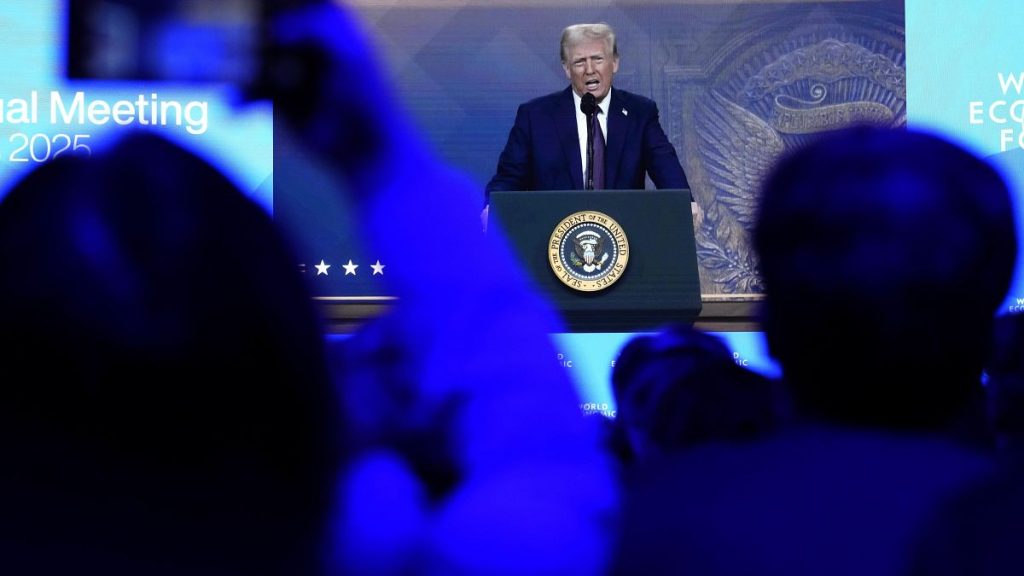 People follow a virtual speech of U.S. president Donald Trump at the Annual Meeting of World Economic Forum in Davos, Switzerland, Thursday, Jan. 23, 2025.