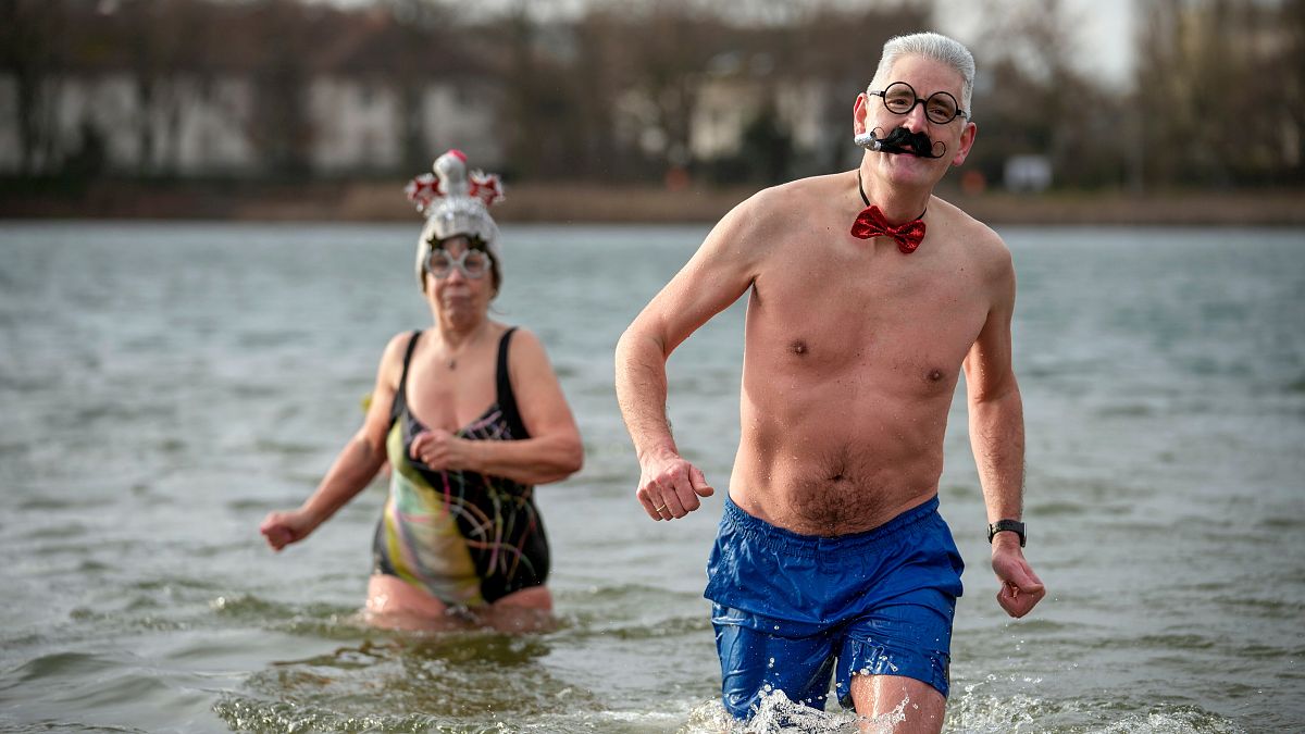 People with fancy hats and caps attend the annual New Year swim with the winter swimming club