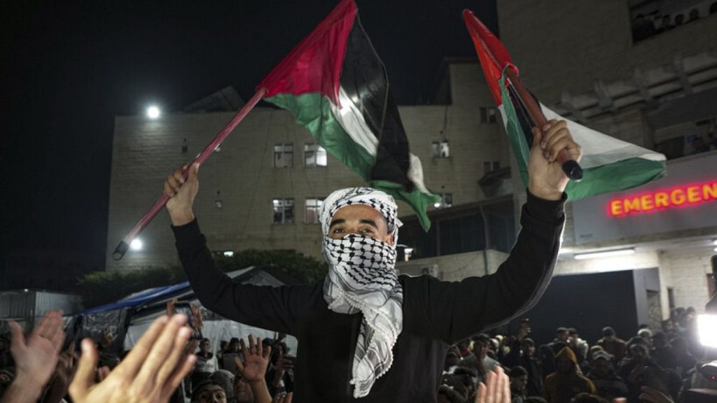 Palestinians celebrate the announcement of a ceasefire deal between Hamas and Israel in Deir al-Balah, central Gaza Strip, Wednesday, Jan. 15, 2025