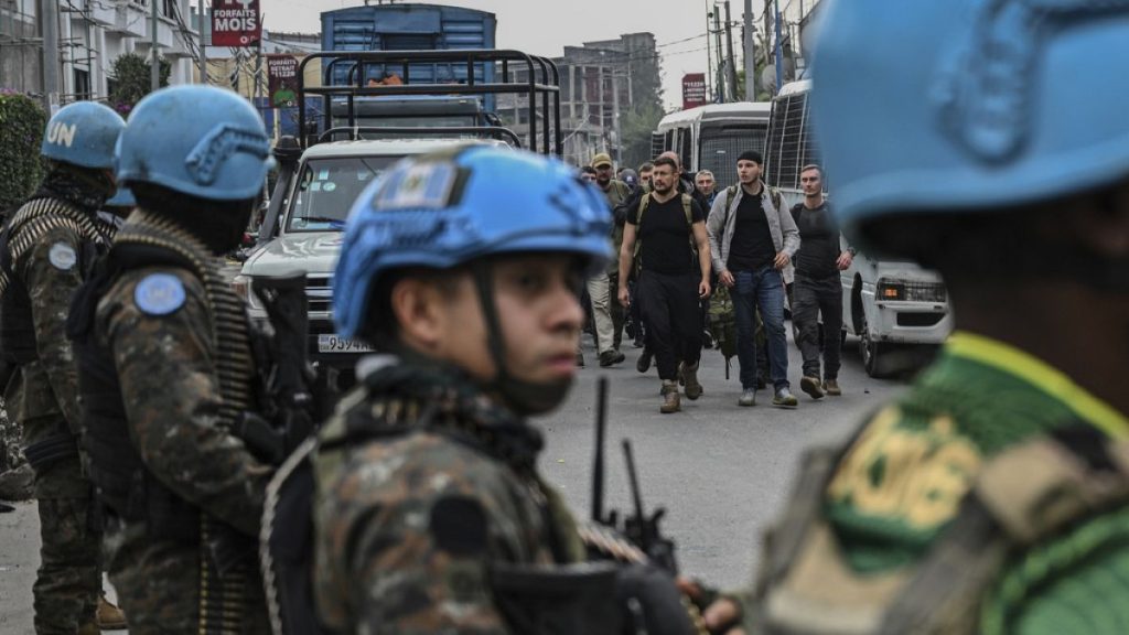 M23 rebels escort Romanian mercenaries past UN peacekeepers to the border crossing into Rwanda in Goma, Democratic Republic of Congo, Wednesday, Jan. 29, 2025.