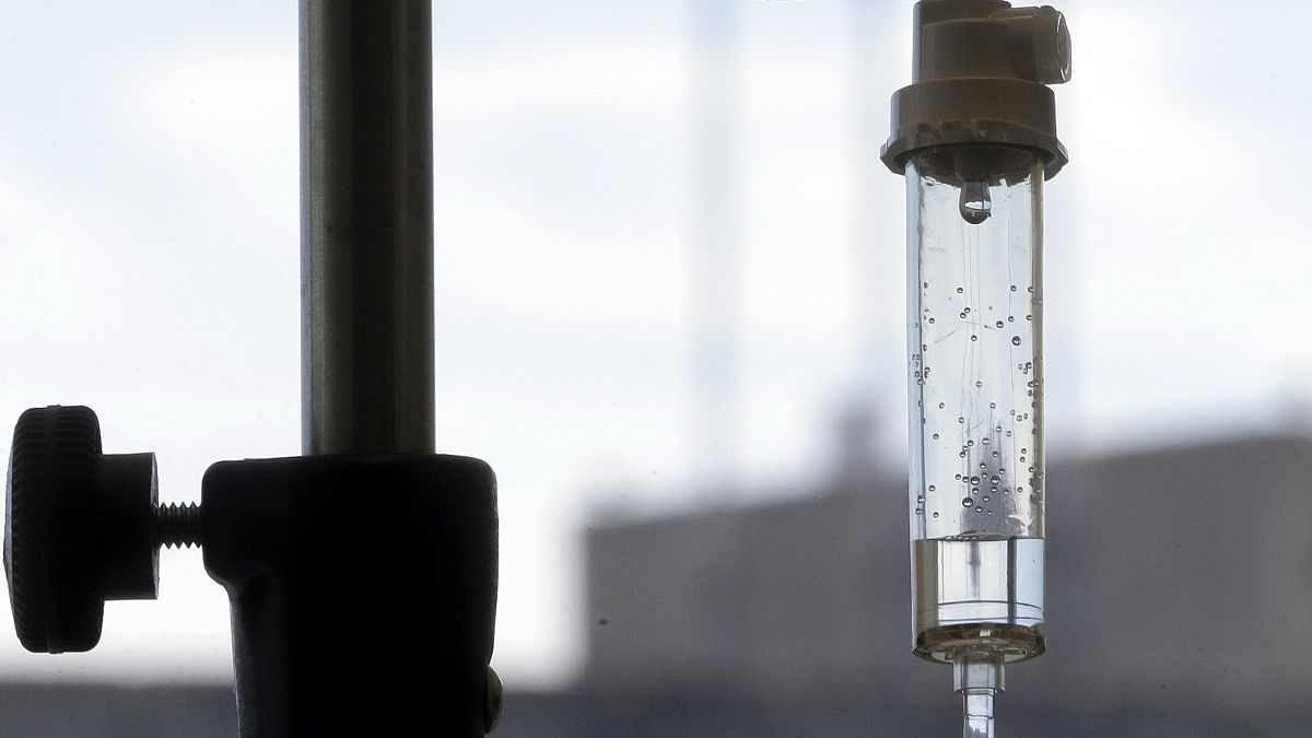 Chemotherapy is administered to a cancer patient via intravenous drip in this photo.