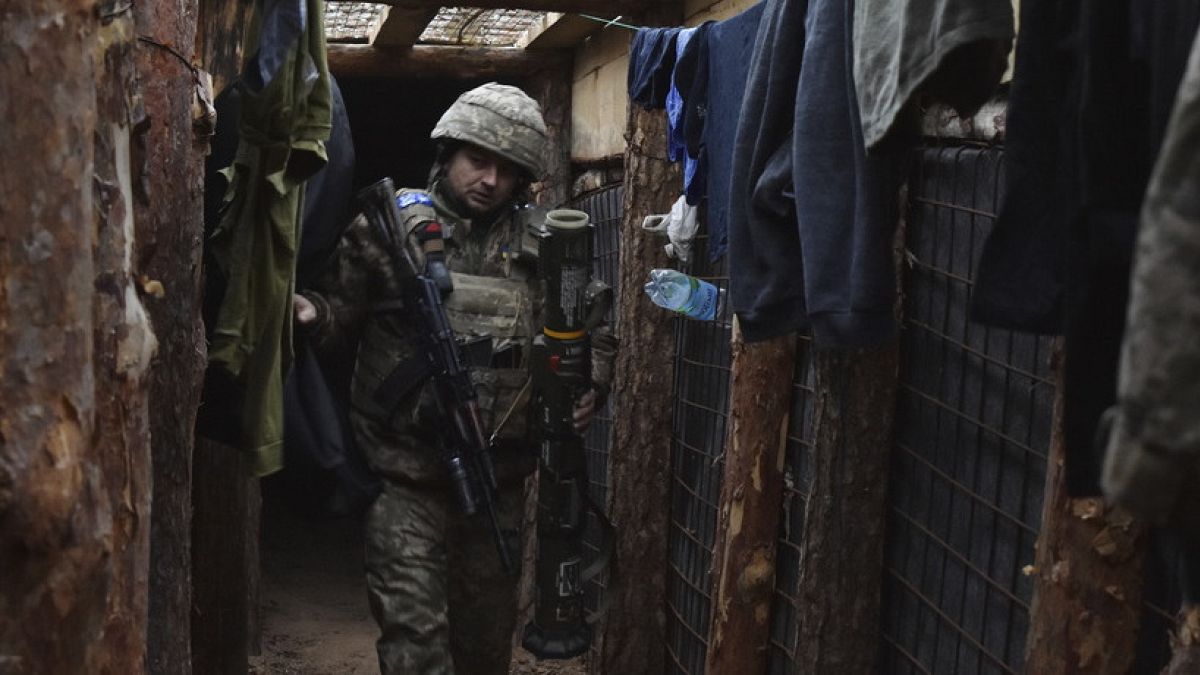 a Ukrainian soldier moves in a trench on the frontline in Zaporizhzhia region, Ukraine, Tuesday, Dec. 31, 2024