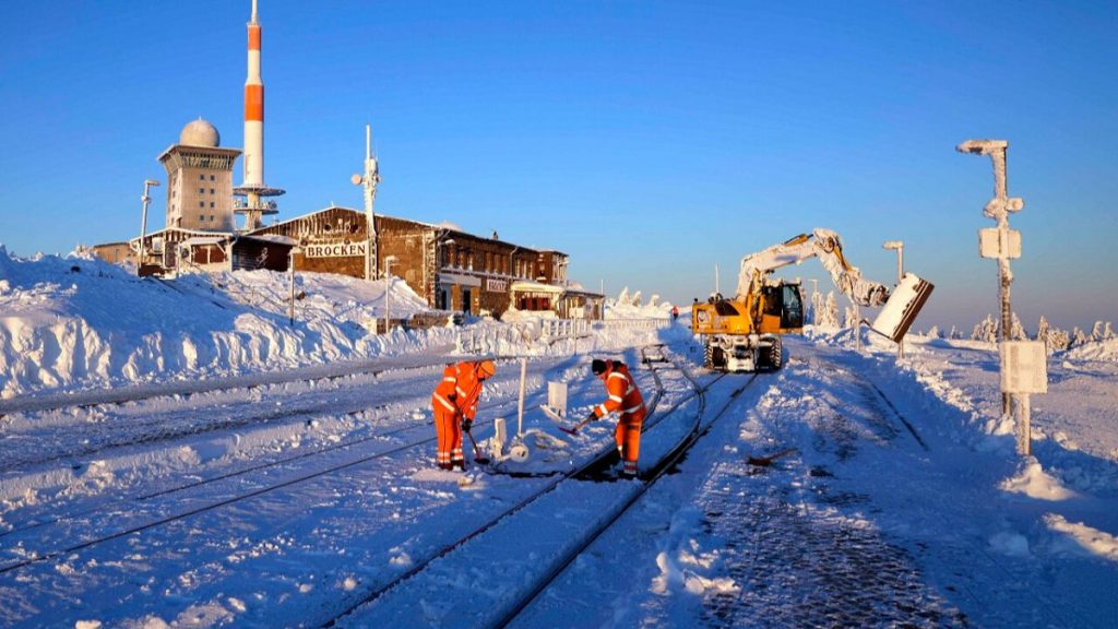 Railroad workers clear the tracks from snow on northern Germany