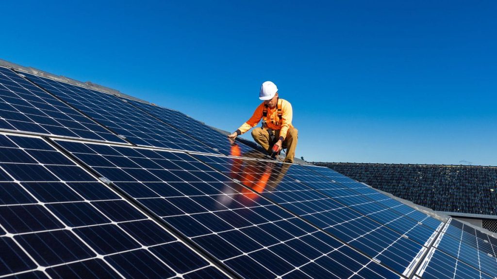 A technician installing solar panels.