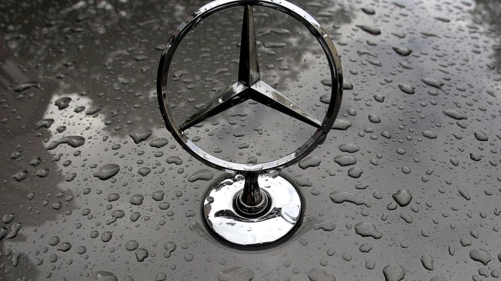 The logo of German car manufacturer Mercedes-Benz is rain covered at a car in Munich, Germany, Friday, July 28, 2017.