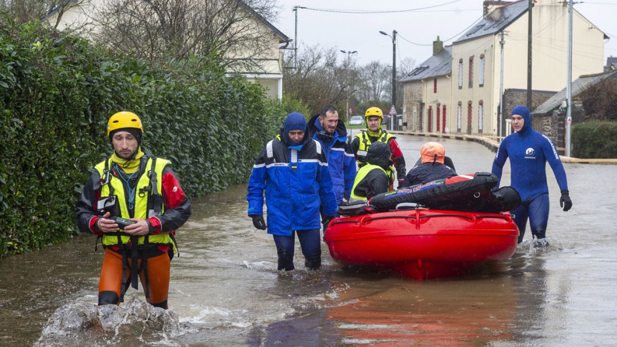 Police officers and rescuers evacuate residents as severe flooding hits western France during Storm Ivo on Wednesday, January 29, 2014, in Redon, western France.