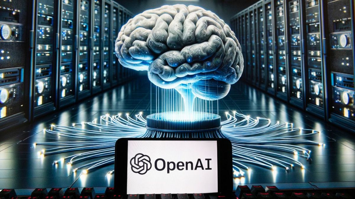 The OpenAI logo is seen displayed on a cell phone with an image on a computer monitor generated by ChatGPT