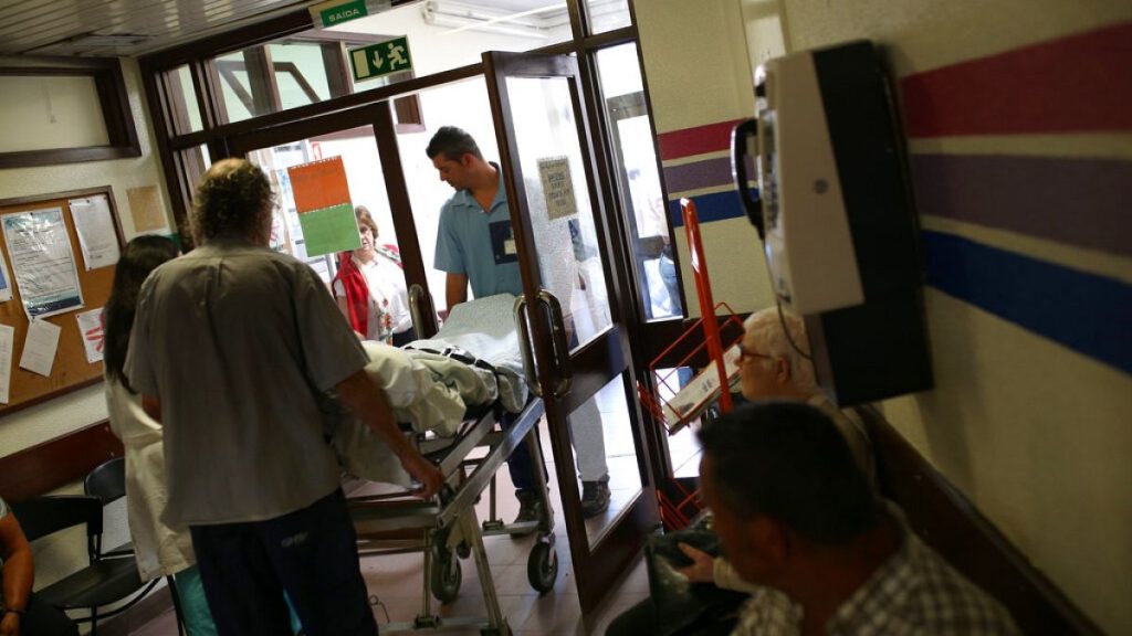 A patient is carried out on a stretcher by hospital assistants at the Sao Jose hospital during a 48-hour nurses