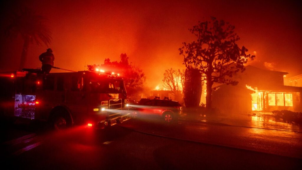 Fire crews battle the Palisades Fire as it burns multiple structures in the Pacific Palisades neighborhood of Los Angeles, Tuesday, Jan. 7, 2025.