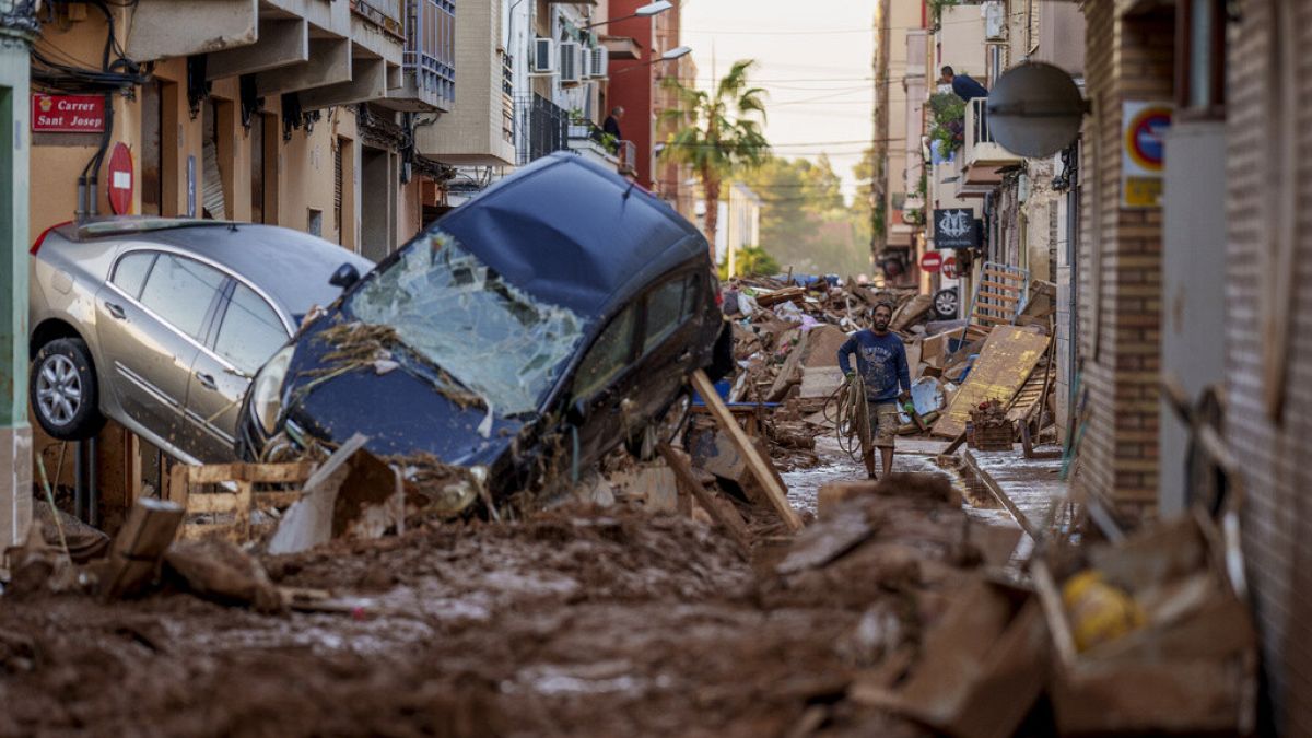 FILE: A man walks through a street affected by floods in Valencia, Spain, Nov. 2, 2024.