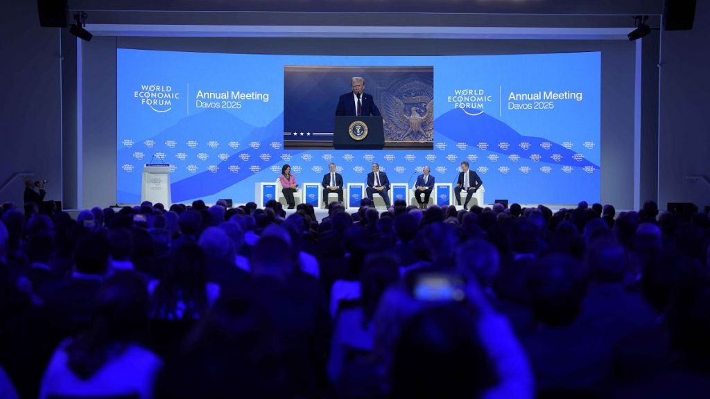 People follow a virtual speech of U.S. president Donald Trump at the Annual Meeting of World Economic Forum in Davos, Switzerland, Thursday, Jan. 23, 2025.