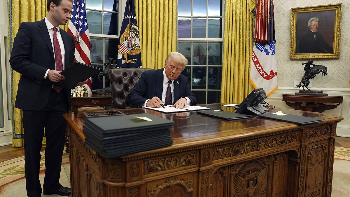 President Donald Trump signs an executive order withdrawing the U.S. from the World Health Organization in the Oval Office