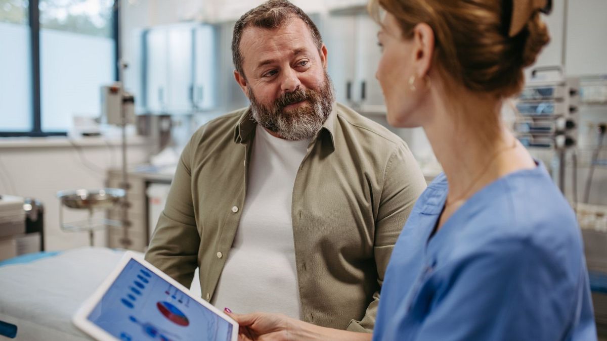 A doctor consults with a patient.