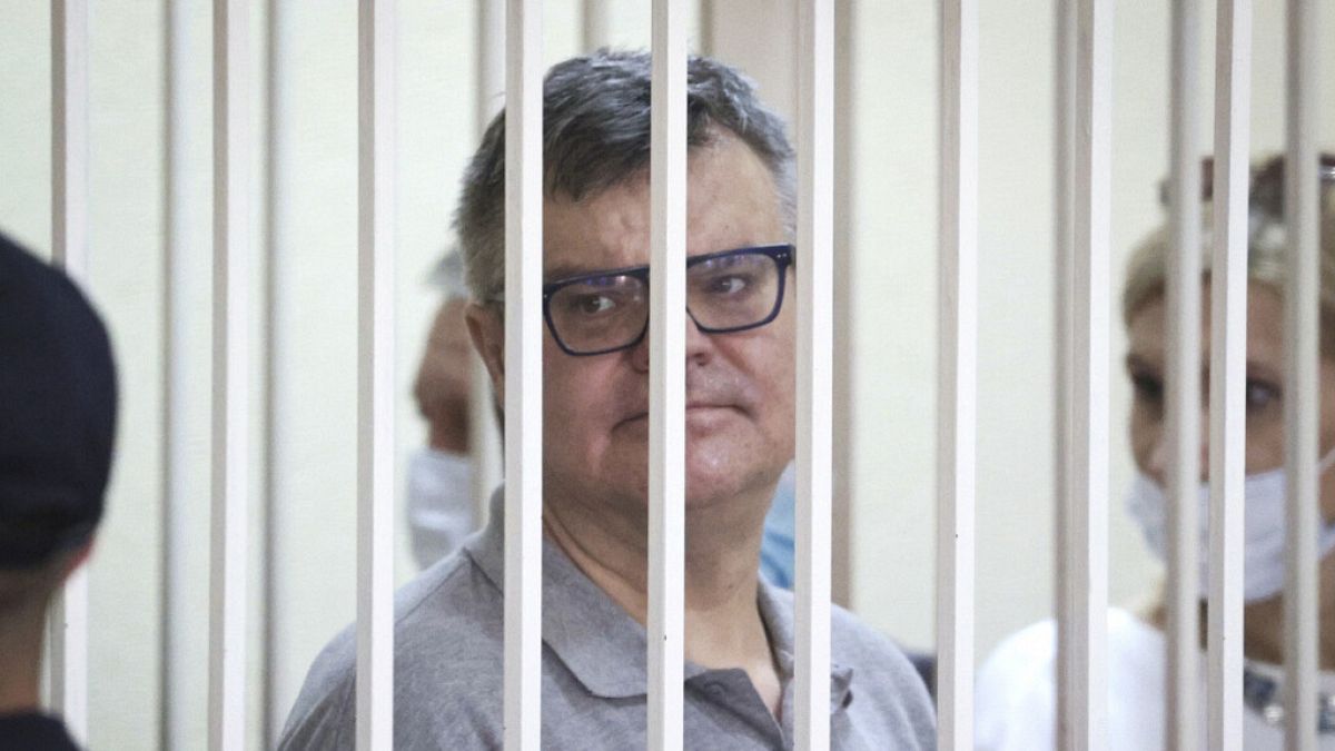 FILE: Viktar Babaryka, a former presidential hopeful, stands inside a defendants’ cage during his trial in Minsk, Belarus, on July 6, 2021