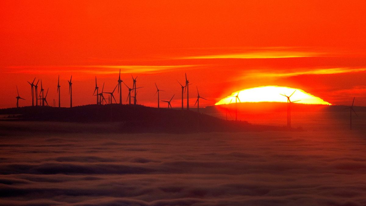 The sun sets next to a wind energy plant in the Taunus region near Frankfurt, Germany, November 2024.