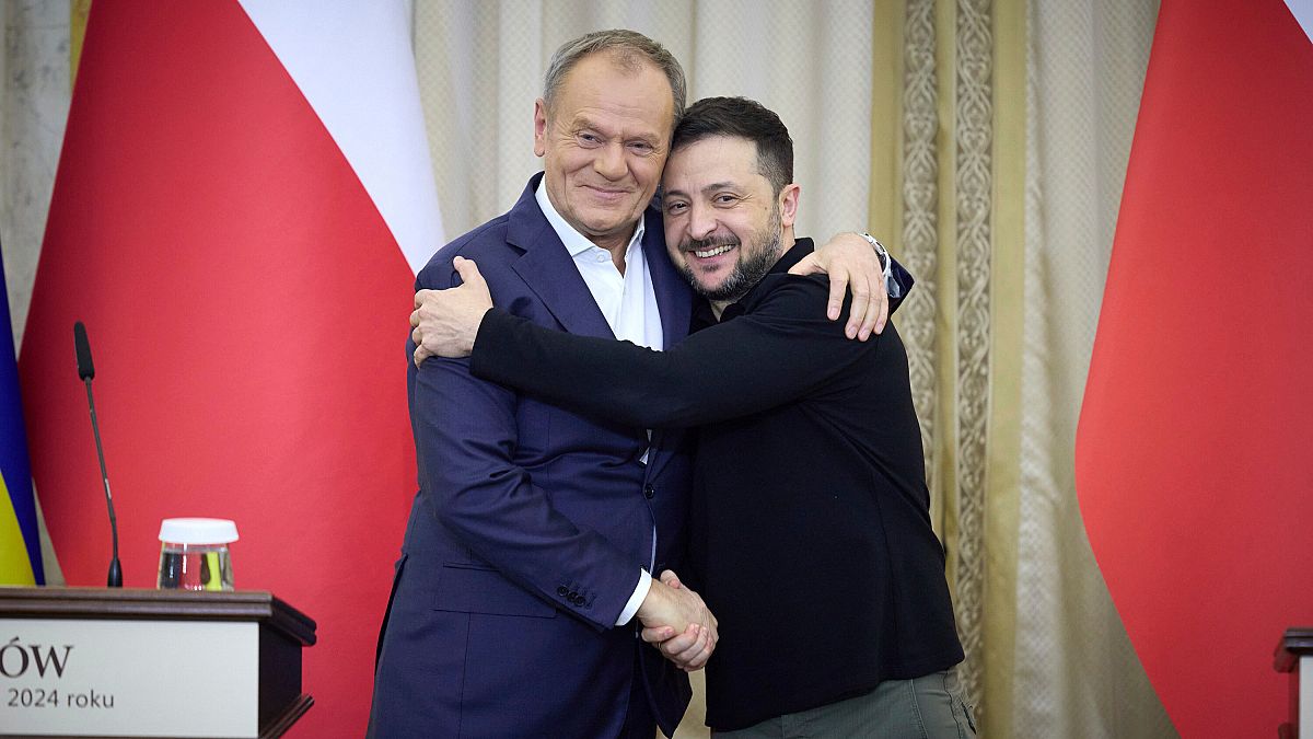 Ukrainian President Volodymyr Zelenskyy, right, shakes hands with Polish Prime Minister Donald Tusk in Lviv, Ukraine, Tuesday, Dec. 17, 2024.