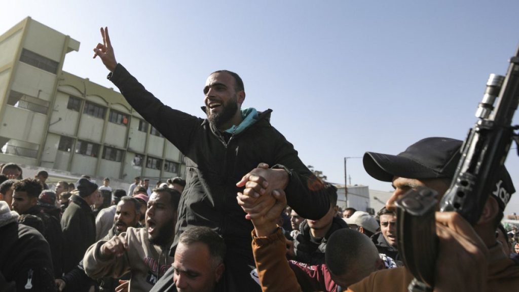 A freed Palestinian prisoner, is greeted by a crowd as he arrives in the Gaza Strip after being released from an Israeli prison following a ceasefire agreement between Hamas a