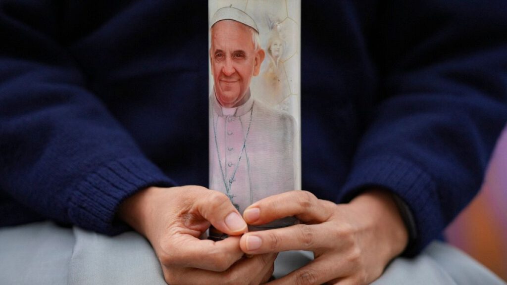 A nun prays for Pope Francis in front of the Agostino Gemelli Polyclinic, in Rome, Sunday, March 9, 2025.