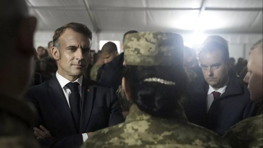 French President Emmanuel Macron, left, and French Defence Minister Sebastien Lecornu, right, spoke with Ukrainian soldiers in a military camp in eastern France