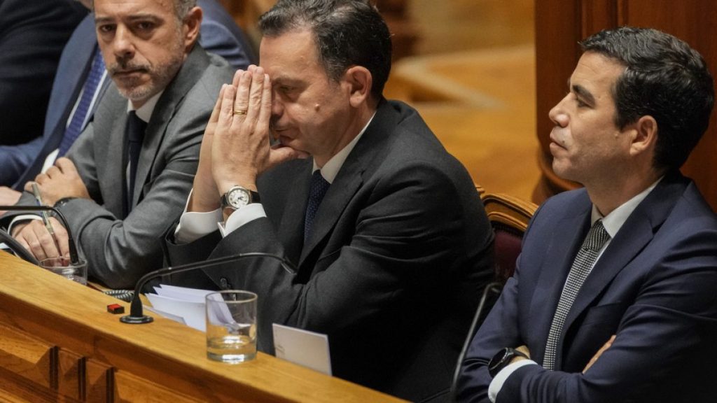 Portuguese Prime Minister Luis Montenegro, second right, gestures during a debate preceding a confidence motion vote at the Portuguese parliament in Lisbon